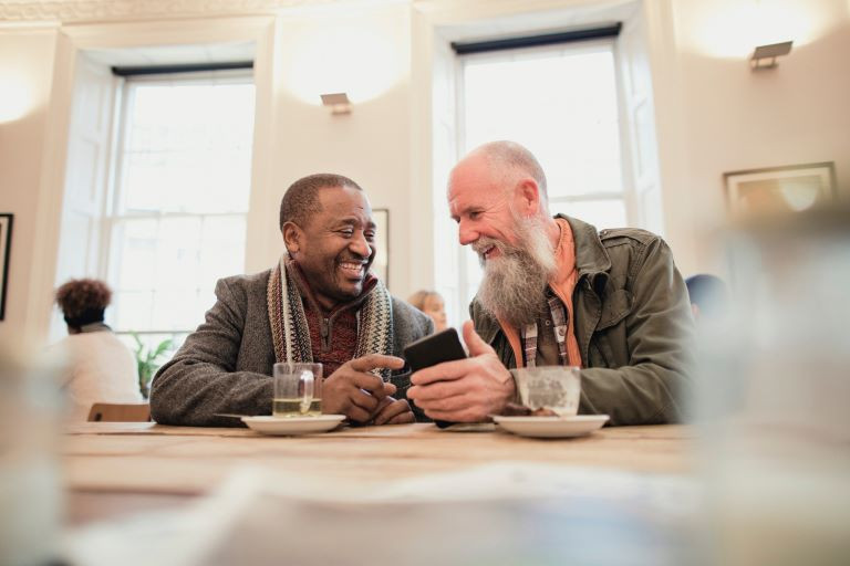 Men sitting down and talking